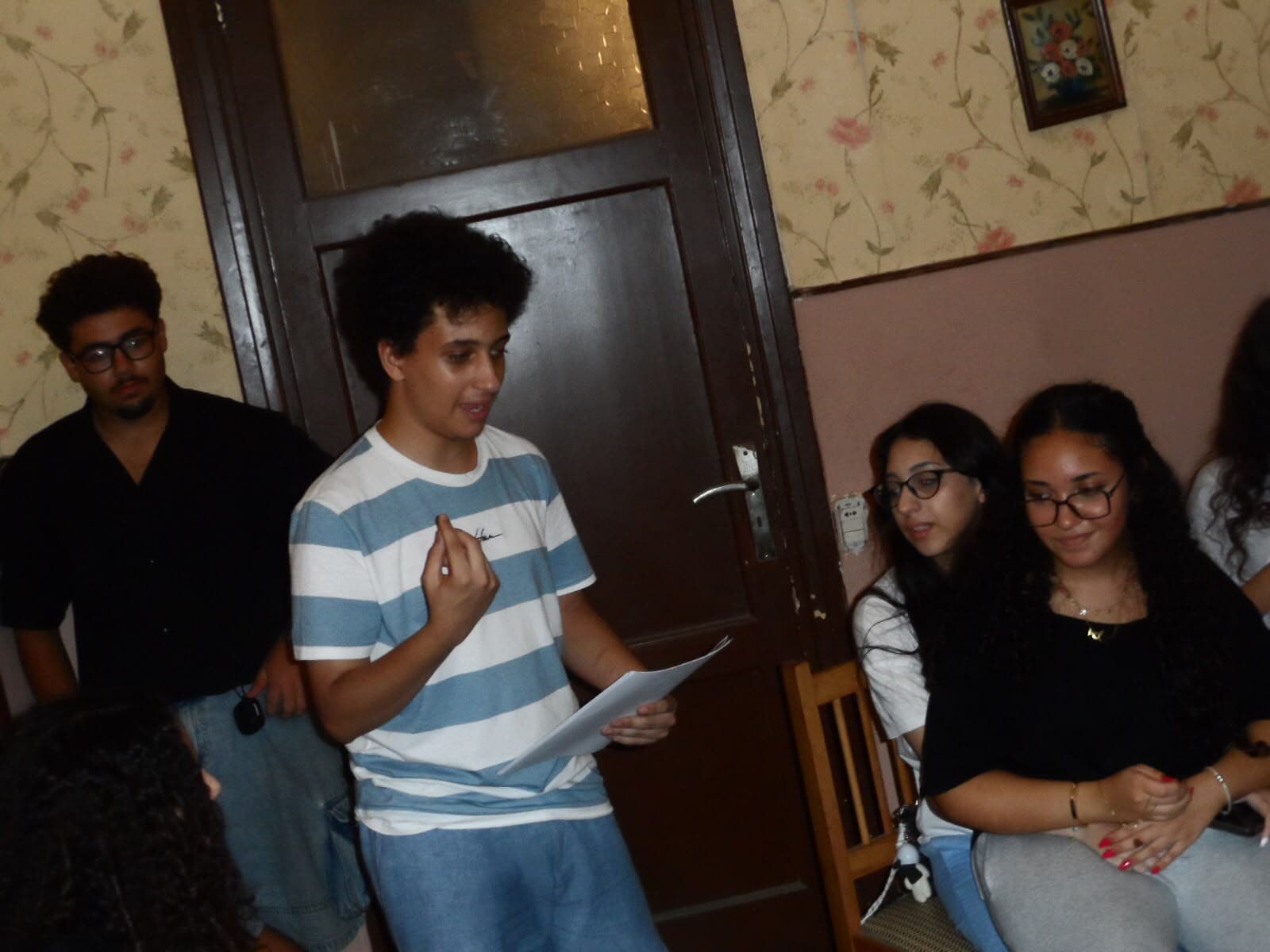 A member presenting clues to the group during the murder mystery